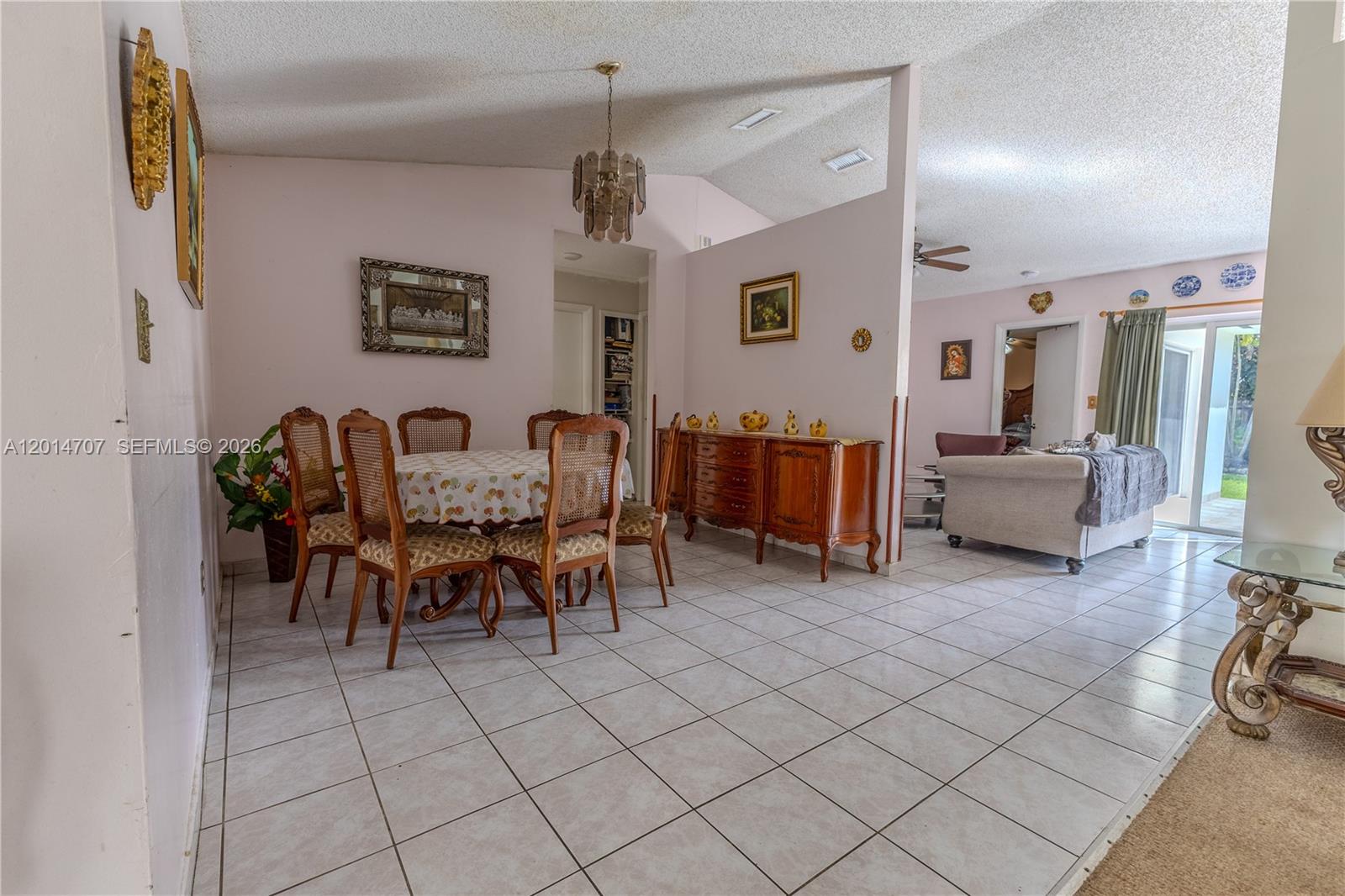 14452 Southwest 115th Street Miami, FL 33186 - Photo 4 of 17 a living room with furniture and a dining table