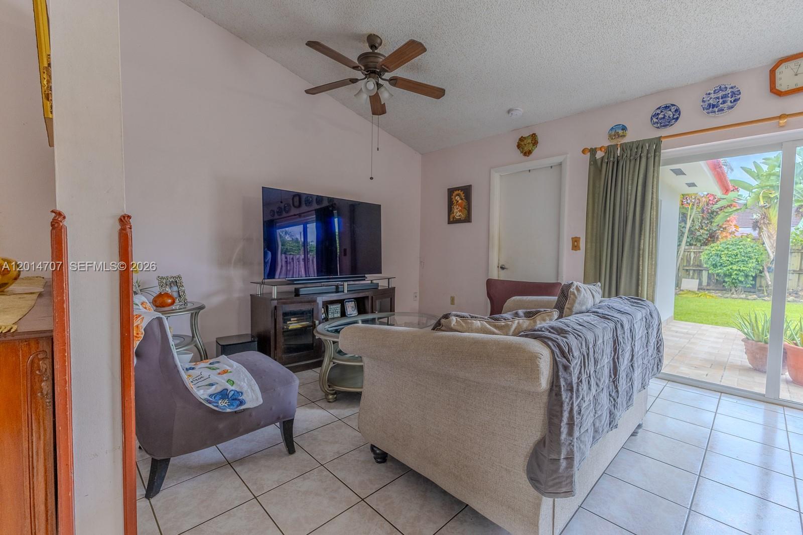 14452 Southwest 115th Street Miami, FL 33186 - Photo 7 of 17 a bed room with furniture and a flat screen tv