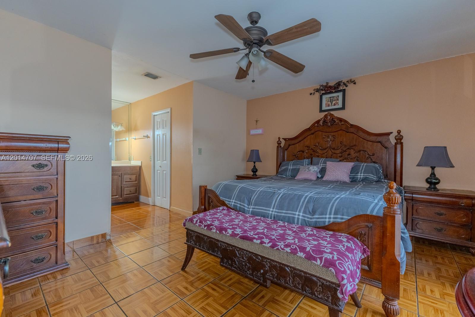 14452 Southwest 115th Street Miami, FL 33186 - Photo 9 of 17 a bedroom with a bed a dresser and potted plants