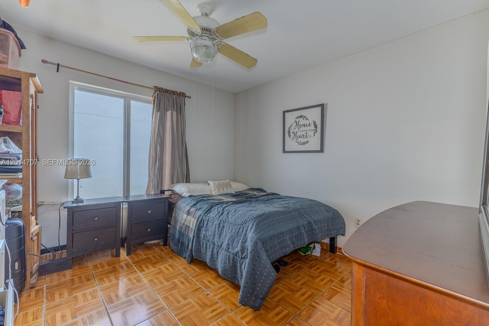 14452 Southwest 115th Street Miami, FL 33186 - Photo 10 of 17 a bedroom with a bed and a cabinets