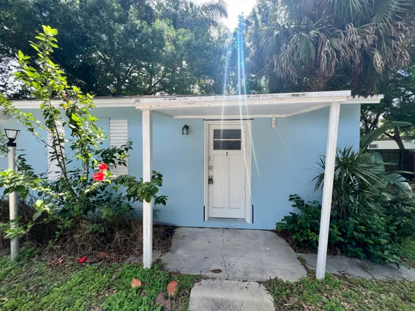 a front view of a house with a yard and flowers
