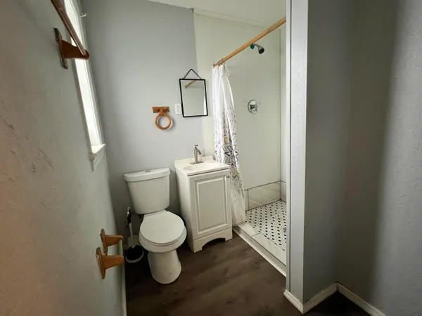 a white toilet sitting next to a bathroom sink