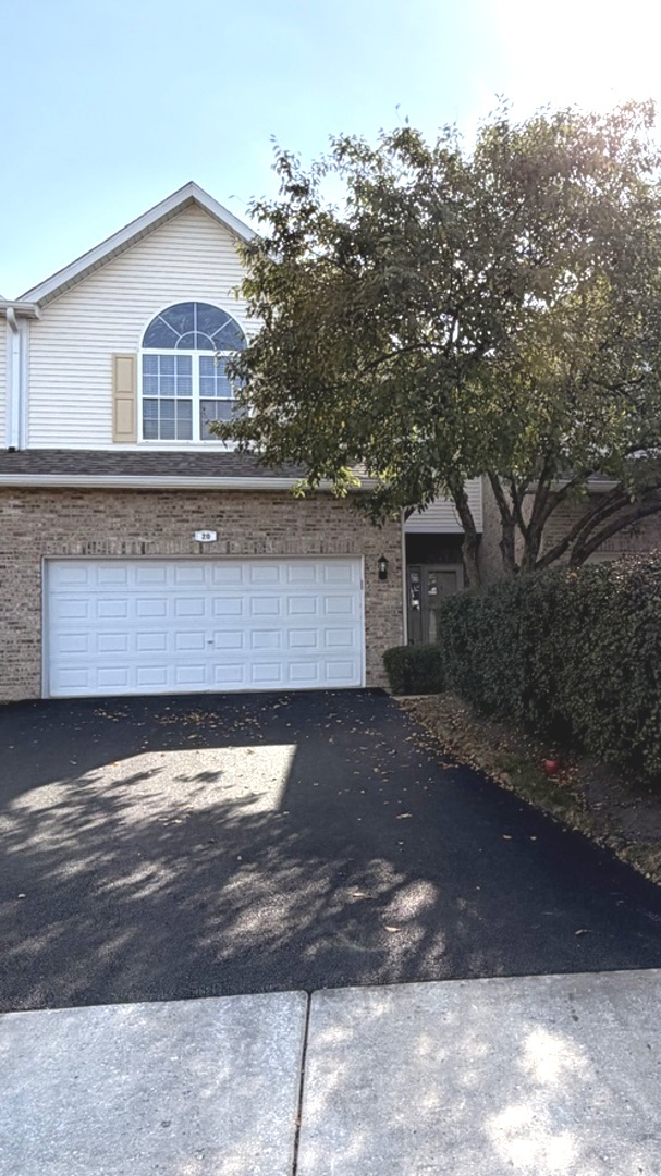 20 Lily Court Bolingbrook, IL 60440 - Photo 1 of 1 a front view of a house with a yard and garage