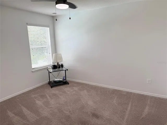 a view of a house with a big yard and large trees