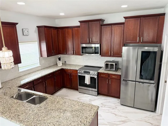 a kitchen with a stove sink and microwave