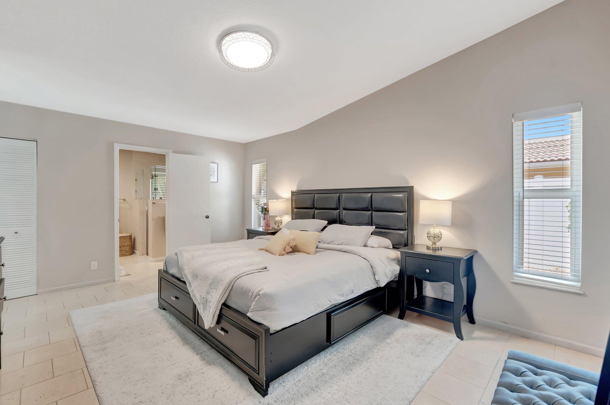 22740 Bella Rita Circle Boca Raton, FL 33433 - Photo 17 of 50 a bedroom with a bed and window