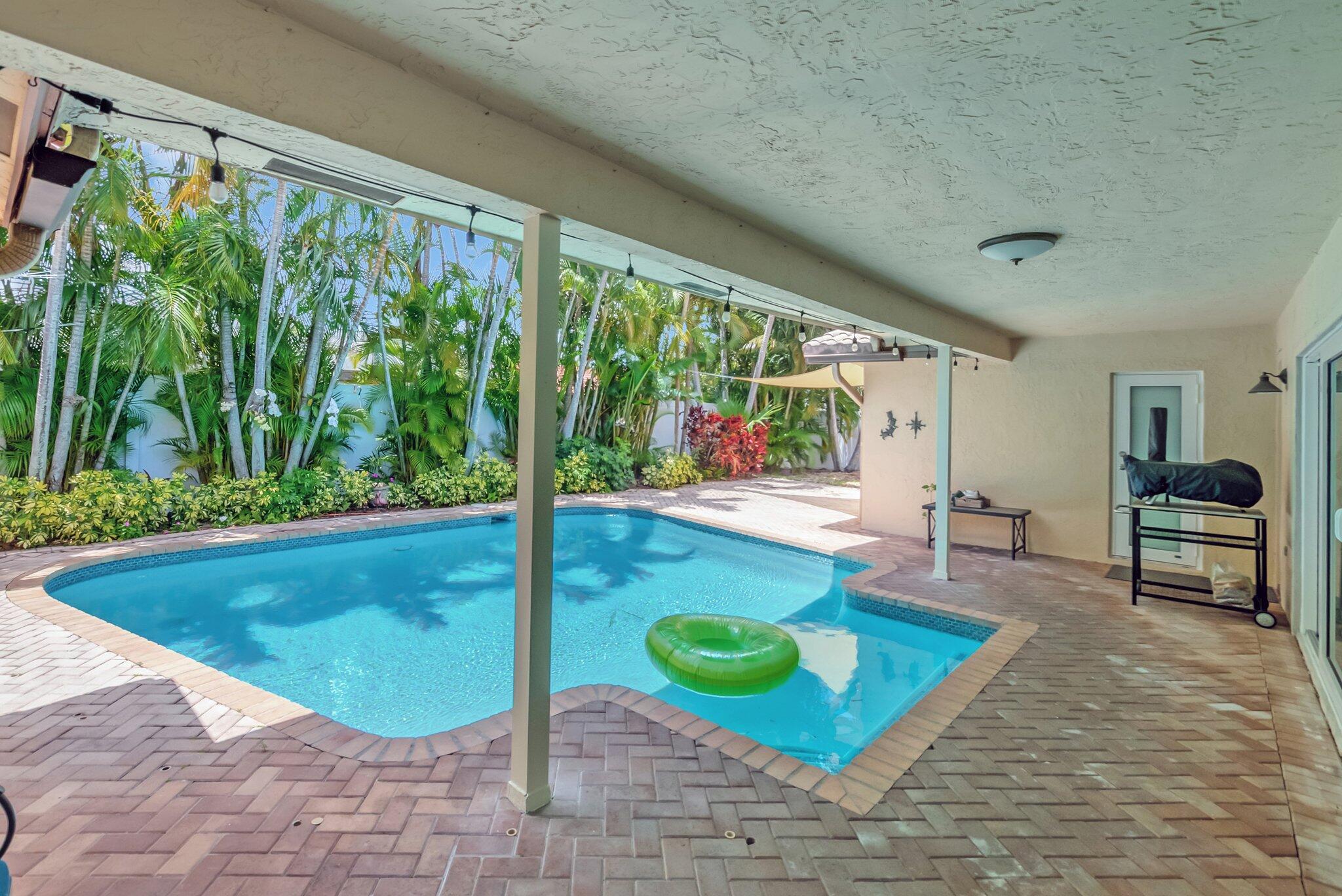 22740 Bella Rita Circle Boca Raton, FL 33433 - Photo 38 of 50 a living room with a floor to ceiling window next to a yard