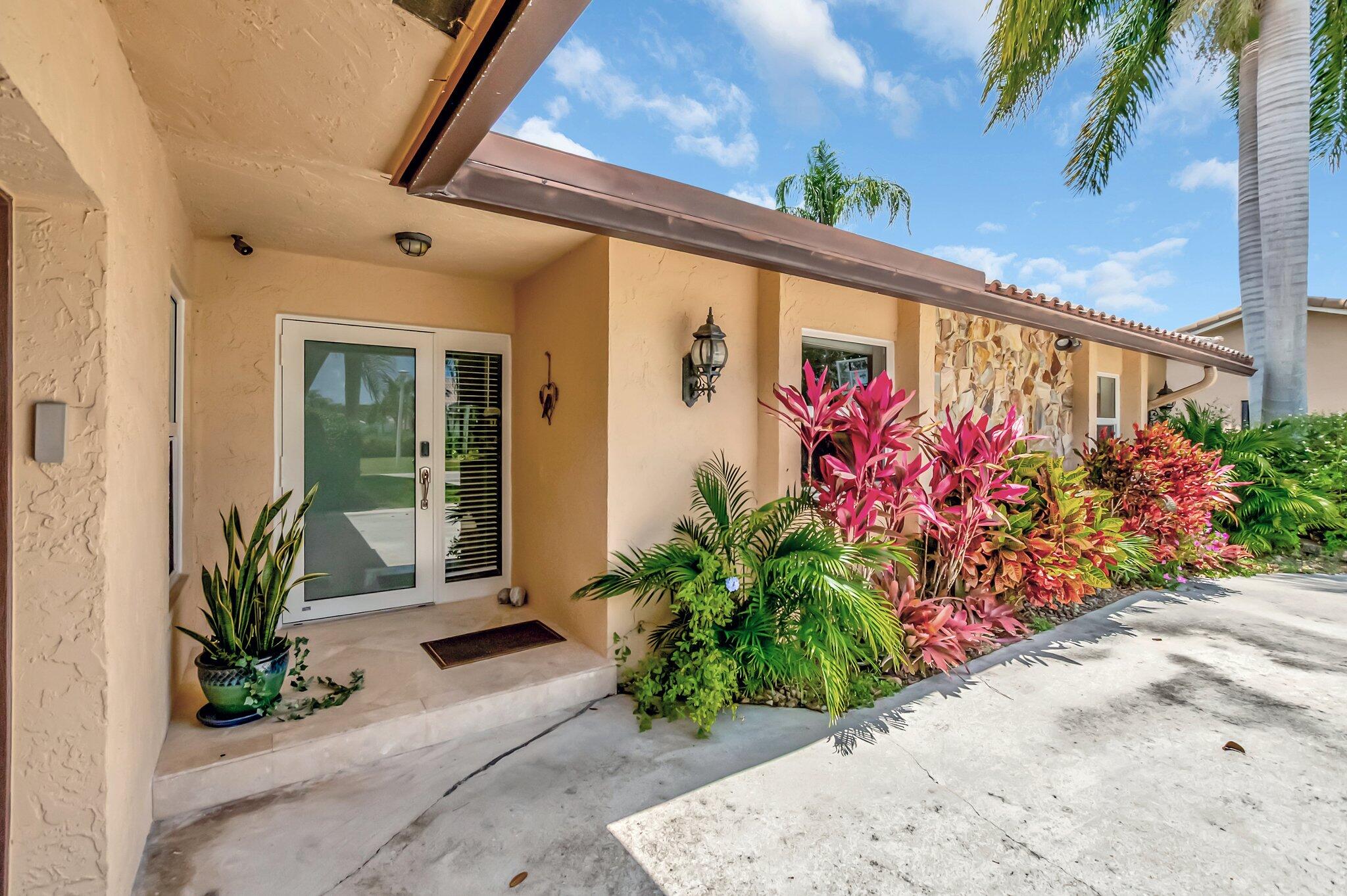 22740 Bella Rita Circle Boca Raton, FL 33433 - Photo 4 of 50 a front view of a house having yard