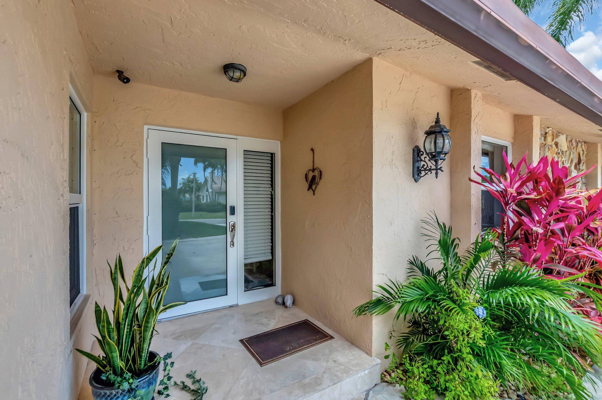 22740 Bella Rita Circle Boca Raton, FL 33433 - Photo 5 of 50 a potted plant sitting in front of a house