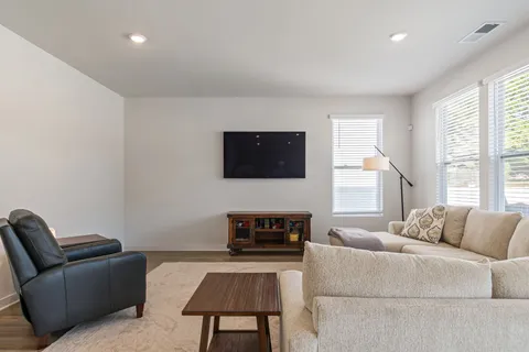 a kitchen with kitchen island a appliances dining table and chairs
