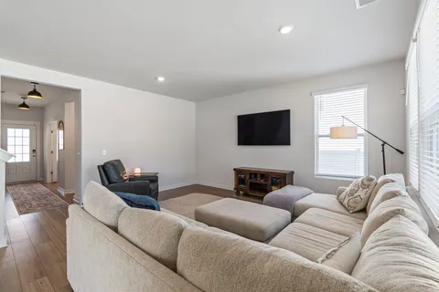 a kitchen with kitchen island a white counter top space a sink stainless steel appliances and cabinets