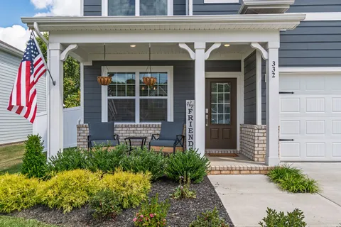 a front view of a house with a garden