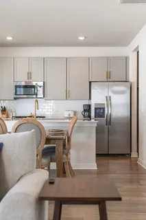 a kitchen with stainless steel appliances granite countertop a sink a stove a microwave and cabinets