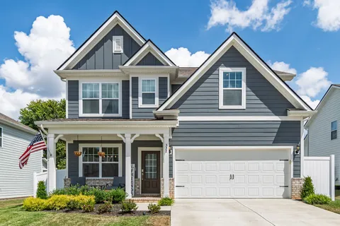 a front view of a house with plants