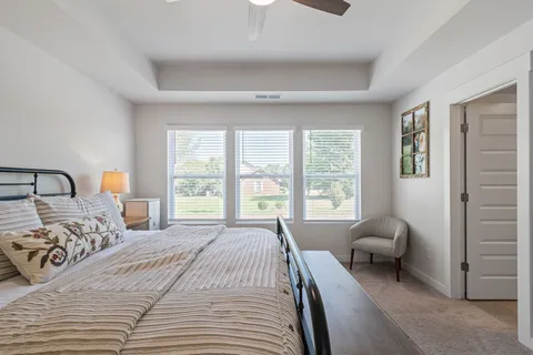 a view of house with yard and sitting area
