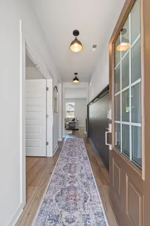 a view of room with wooden floor and windows