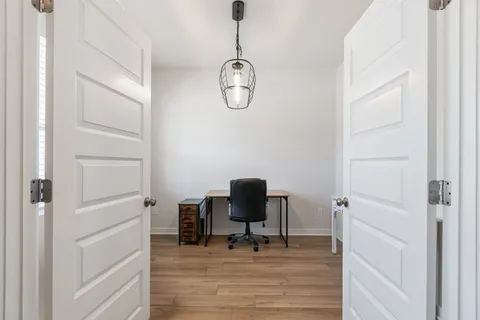 a living room with furniture a flat screen tv and a large window