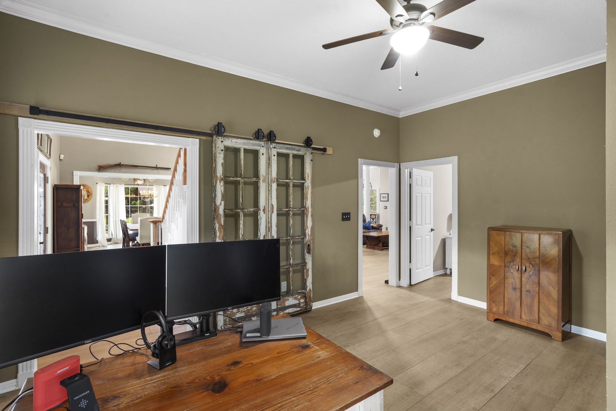 19610 Timber Ridge Drive Magnolia, TX 77355 - Photo 22 of 50 It features classic crown molding and offers convenient access from the front entry, living room, and primary bedroom, creating a private yet connected workspace ideal for modern living.