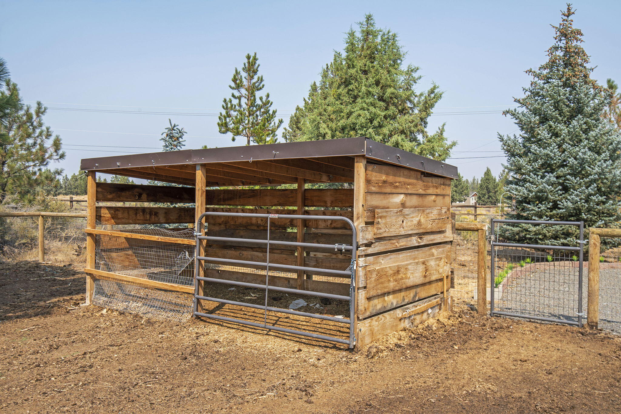 66901 Lance Road Bend, OR 97703 - Photo 61 of 71 a view of a house with a large window and wooden fence