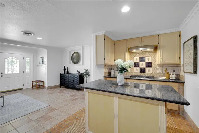 a kitchen with sink and refrigerator