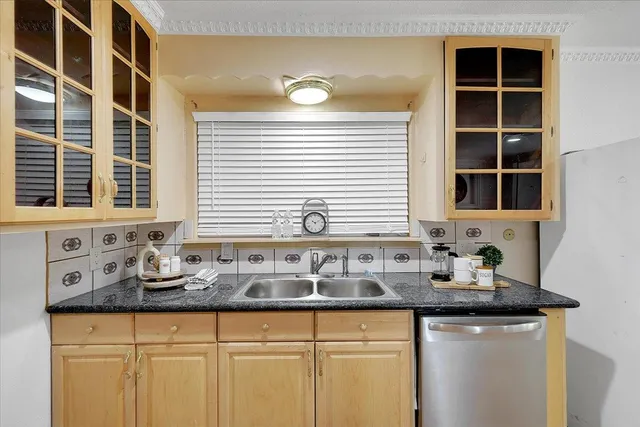 a kitchen with granite countertop a sink and a window