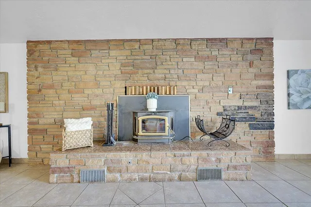 a workspace room with furniture and window