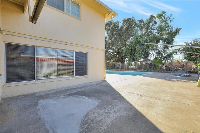 a view of a swimming pool with a yard