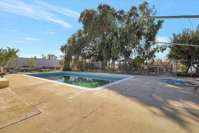 a view of a swimming pool with a yard