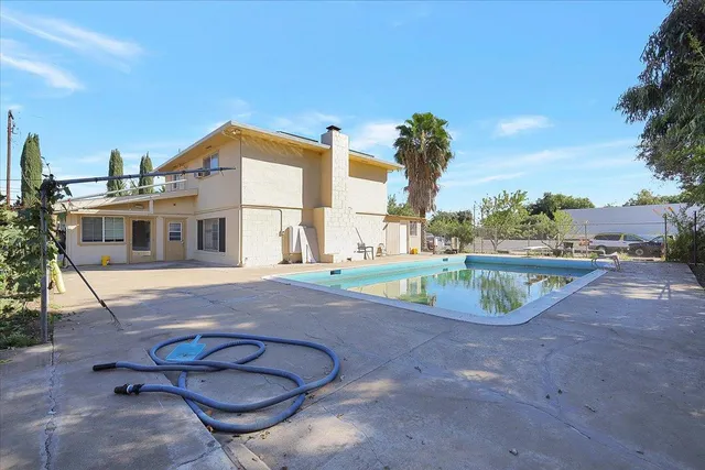 a view of a swimming pool with a chair and tables