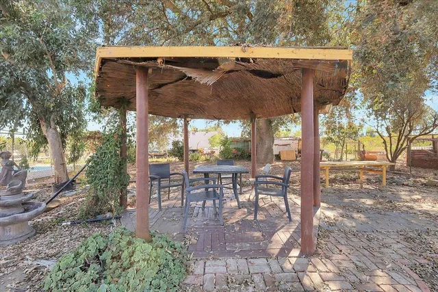 a view of a chairs and table in backyard