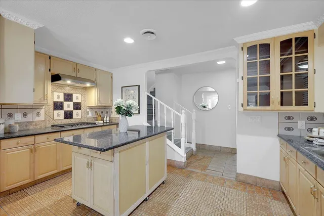 a kitchen with cabinets a sink and stainless steel appliances