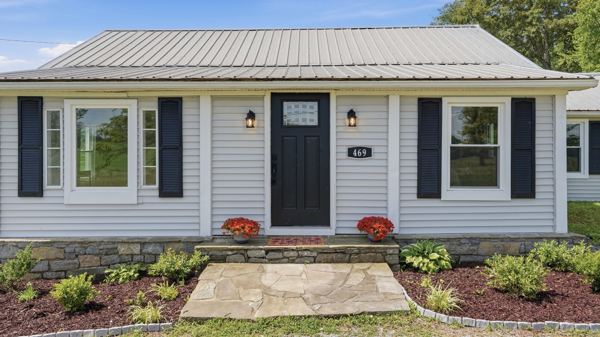 469 Fred Cooper Road McMinnville, TN 37110 - Photo 5 of 46 a view of a brick house with potted plants