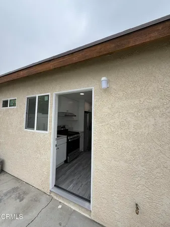 a view of a hallway with wooden shelves and cabinets