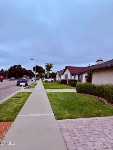 a view of house with garden space and sitting area