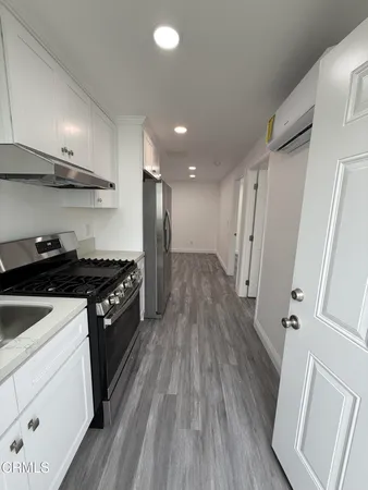 a kitchen with stainless steel appliances granite countertop a stove and a refrigerator