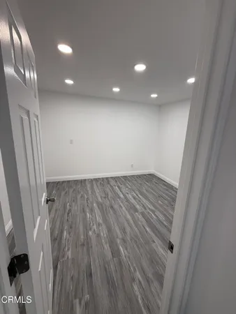 wooden floor in an empty room with a mirror