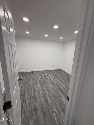 wooden floor in an empty room with a mirror