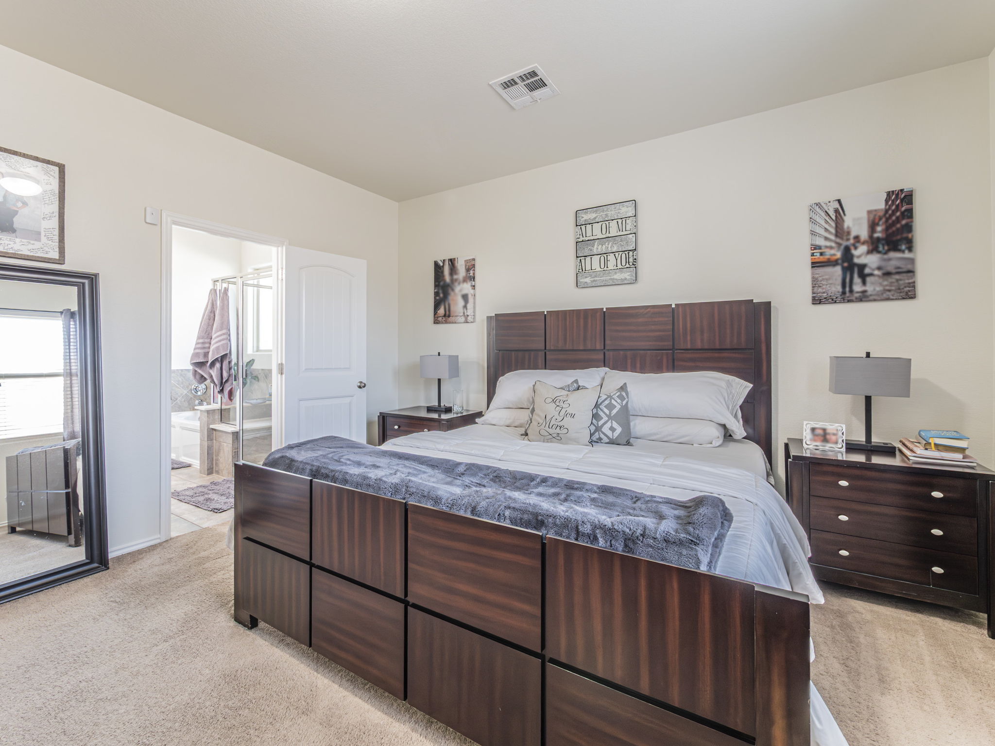 1366 Heep Run Buda, TX 78610 - Photo 10 of 35 Owner Suite Bedroom on the main floor featuring light colored carpet and connected bathroom