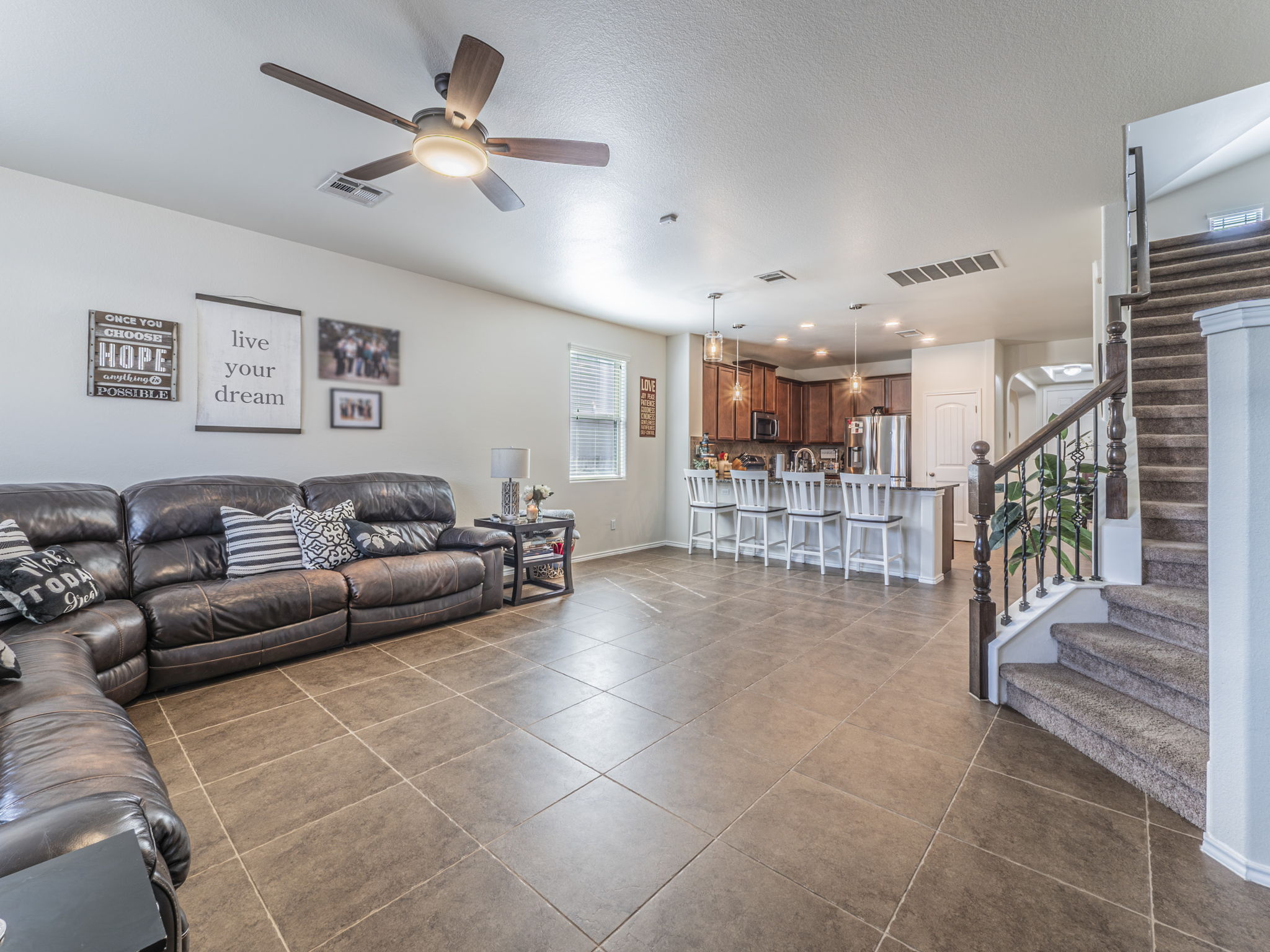 1366 Heep Run Buda, TX 78610 - Photo 5 of 35 Living room with ceiling fan, dark tile patterned floors, and a textured ceiling