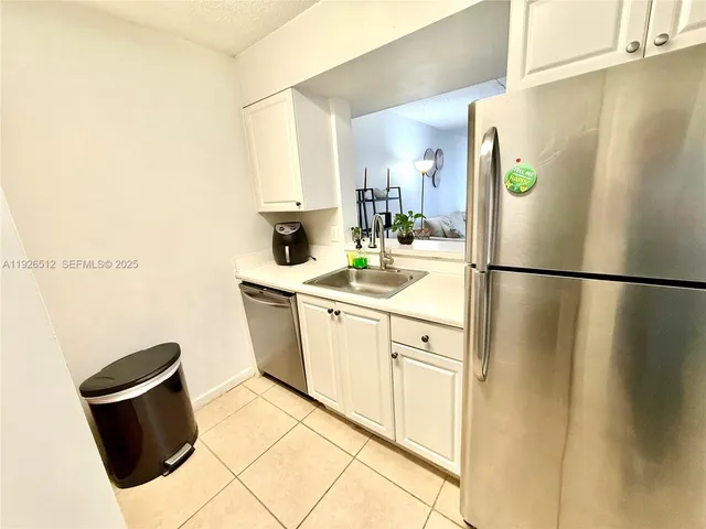 a kitchen with stainless steel appliances a sink a stove and a refrigerator
