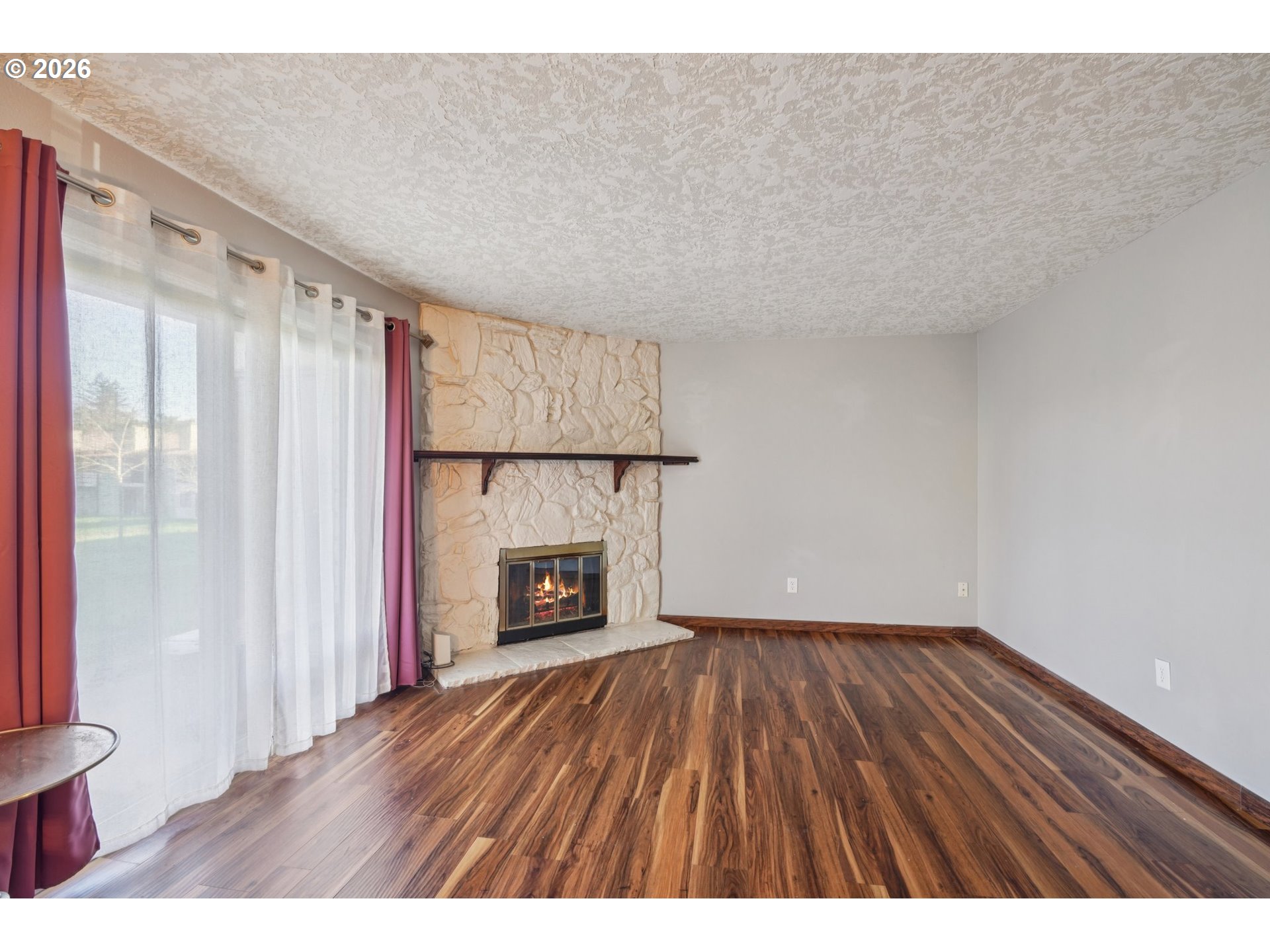 3383 Northeast 162nd Avenue Portland, OR 97230 - Photo 6 of 27 a view of an empty room with a fireplace and a window