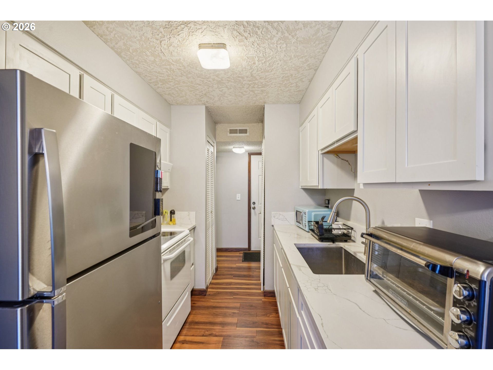 3383 Northeast 162nd Avenue Portland, OR 97230 - Photo 9 of 27 a kitchen with a refrigerator and a sink