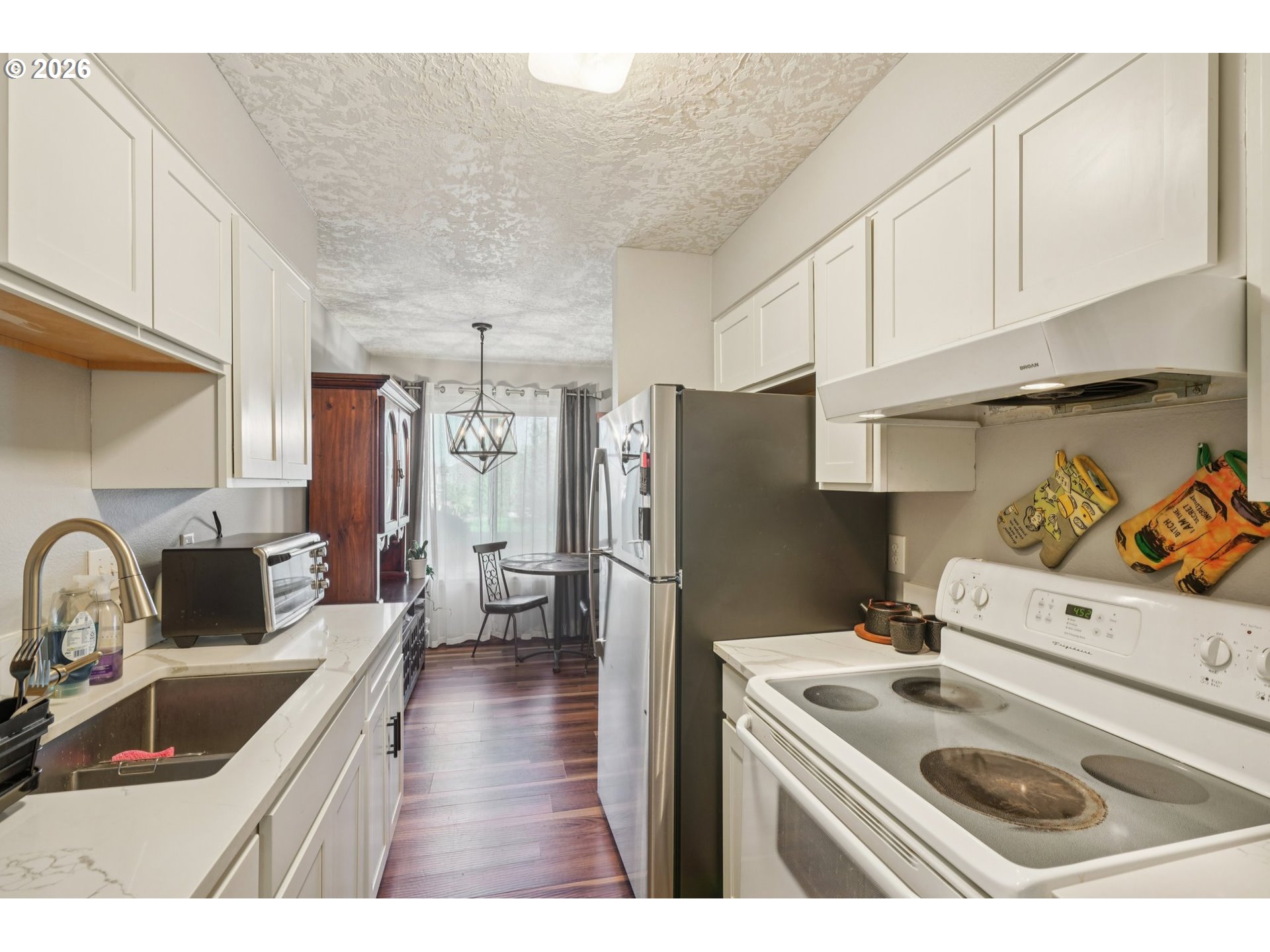 3383 Northeast 162nd Avenue Portland, OR 97230 - Photo 10 of 27 a kitchen with stainless steel appliances granite countertop a sink stove and refrigerator