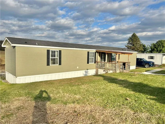 a view of house that has a big yard