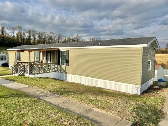 a view of a backyard with plants and a patio