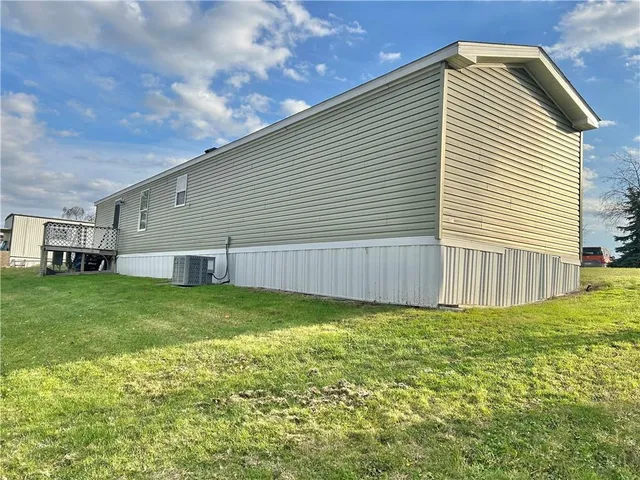 a backyard of a house with table and chairs