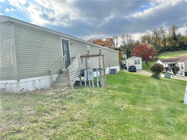 a view of a livingroom with wooden floor and a flat screen tv