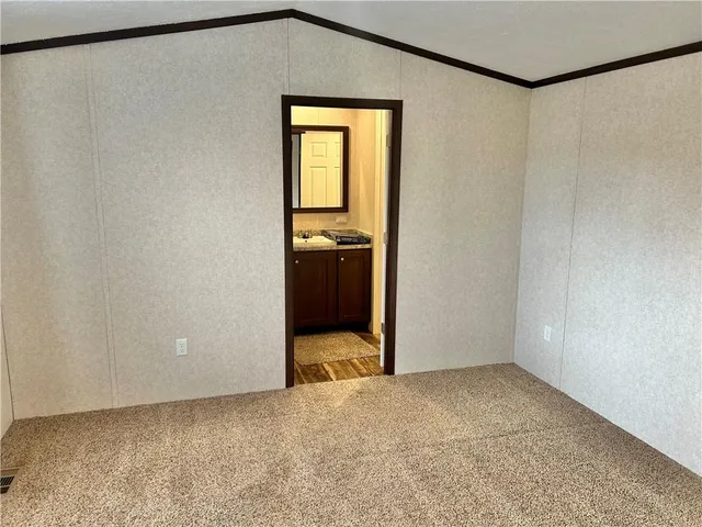 a view of a room with wooden floor and white walls