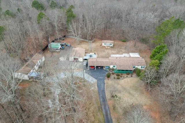 a view of a house with a yard and sitting area
