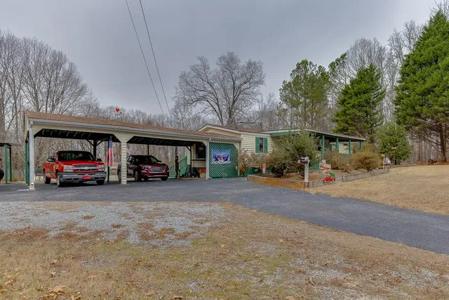 a view of a house with a patio and a parked car